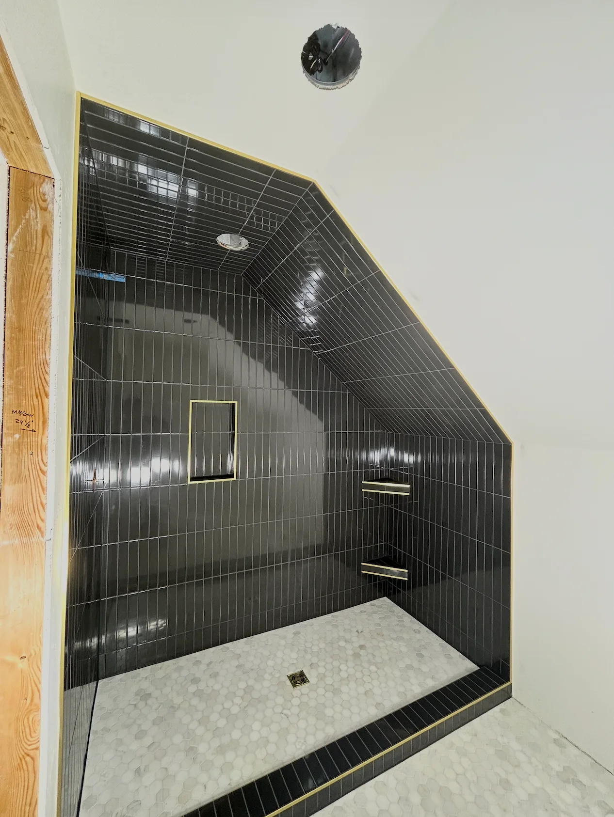 Custom black tile shower with gold trim